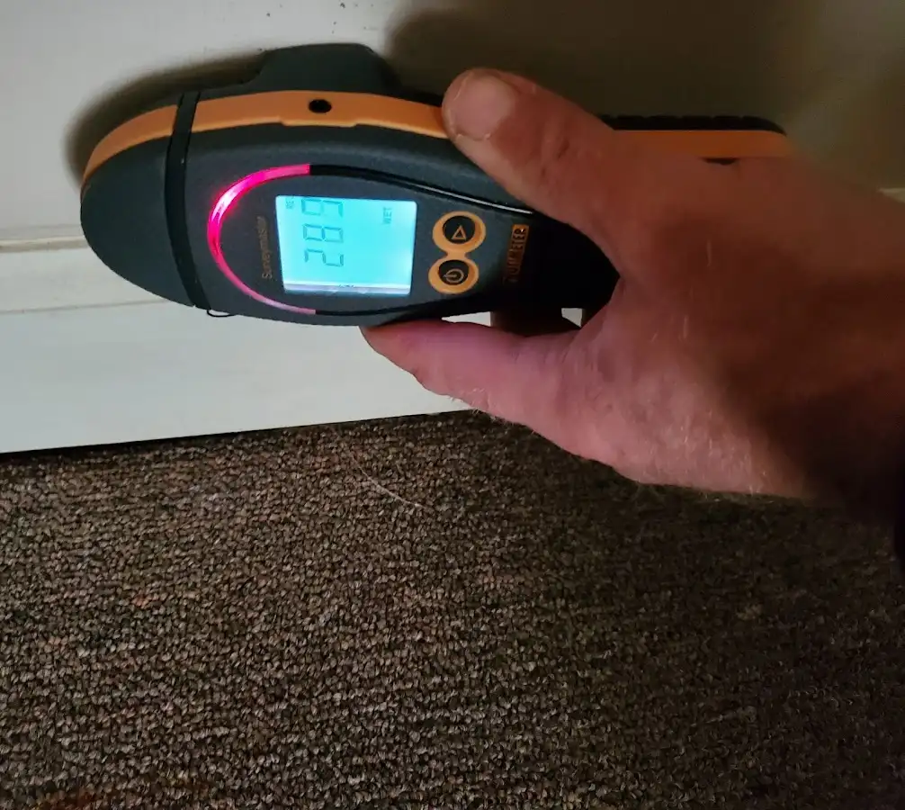 Moisture detection at baseboard during Storm Damage Restoration in Seminole